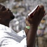 Hundreds of thousands of Muslim pilgrims in white ihram garments covering the slopes of Mount Arafat near Mecca, Saudi Arabia, during Hajj 2026, under a bright desert sky.
