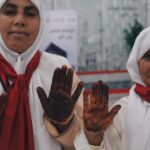 Moroccan female Hajj pilgrims having henna applied at Rabat-Salé Airport before departure to Makkah under the Makkah Route Initiative, May 2026