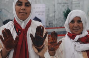 Moroccan female Hajj pilgrims having henna applied at Rabat-Salé Airport before departure to Makkah under the Makkah Route Initiative, May 2026