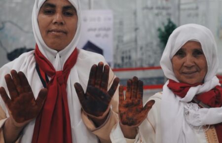 Moroccan female Hajj pilgrims having henna applied at Rabat-Salé Airport before departure to Makkah under the Makkah Route Initiative, May 2026
