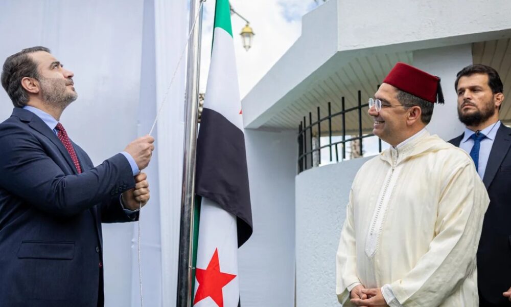 Syrian Foreign Minister Asaad al-Shaibani raises Syria’s flag at the embassy in Rabat alongside Moroccan Foreign Minister Nasser Bourita.